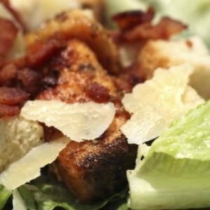Caesar salad with crispy chicken, hardboiled egg and anchovy